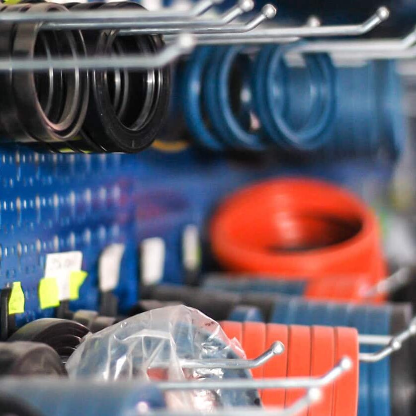 Heavy-duty tool storage with organized wrenches, cables, and accessories in a professional workshop for auto parts inventory management.