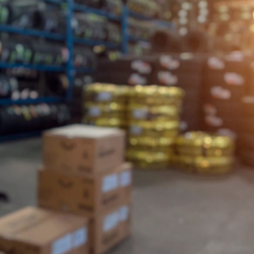 Industrial warehouse inventory storage with shelves of boxes and packaged items, showcasing professional inventory management services.