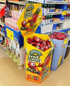 Robinson's Fruit Shoot juice bottles display at a retail store end cap, featuring colorful packaging and promotional signage for kids' beverages.