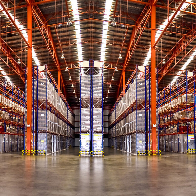 Inventory storage racks in a large warehouse, featuring organized pallets and industrial shelving for efficient inventory management.